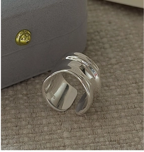 Detail of S925 sterling silver wide open ring with an irregular liquid texture design