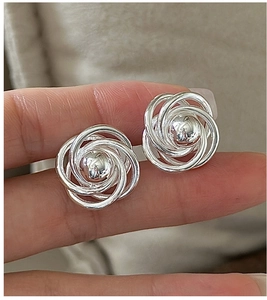 Close-up of S925 sterling silver twist knot earrings with a central metal bead