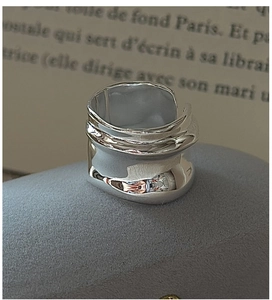 Macro shot of S925 sterling silver wide ring with irregular lava texture finish