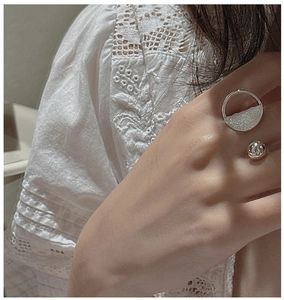 Close-up of S925 sterling silver open ring with brushed texture and polished bead detail