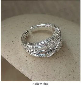 Detailed macro view of S925 sterling silver ring with hollow geometric mesh pattern