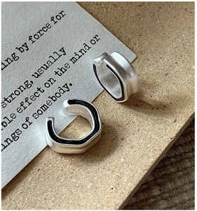 Detailed macro of S925 sterling silver ear cuffs with matte finish and black enamel inlay