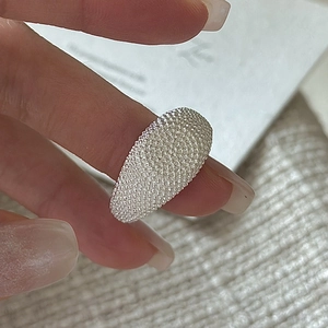 Minimalist S925 sterling silver ring with beaded texture worn on a finger