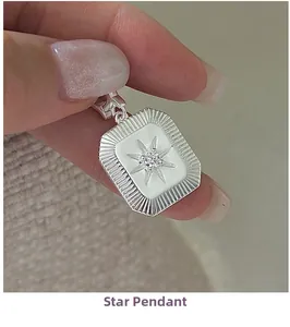 Close-up of S925 sterling silver star pendant with centered diamond and sunburst texture