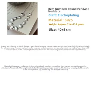 Macro detail of S925 sterling silver matte oval necklace with tiered metal discs