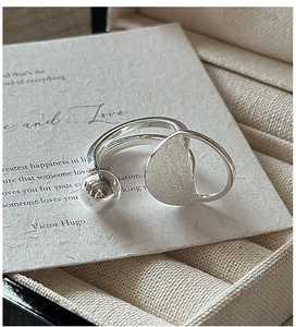 Detailed close-up of S925 sterling silver open ring with brushed texture and polished bead