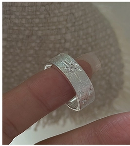Macro detail of S925 sterling silver brushed star ring with a sparkling crystal stone