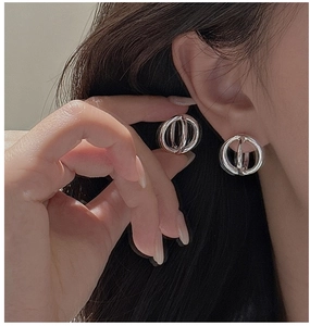 Macro shot of S925 silver hollow geometric hoop earring with polished mirror finish