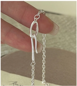 Macro shot of S925 sterling silver stamp on minimalist buckle chain with matte finish