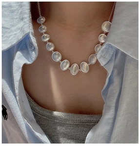 Close-up of S925 sterling silver oval gemstone necklace on a model's neck