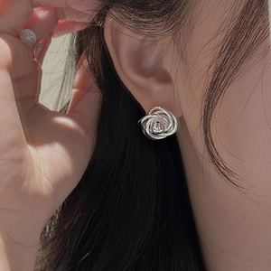 Elegant S925 sterling silver rose bud stud earrings on female model ear close-up