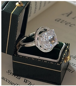 Macro shot of S925 silver ring with cushion cut crystal in a green velvet jewelry box
