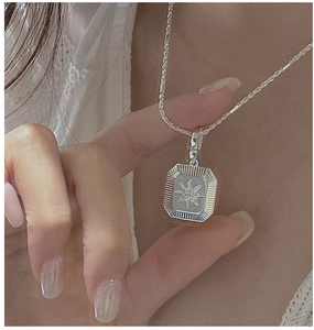 Detailed close-up of S925 sterling silver rectangular starburst compass pendant necklace