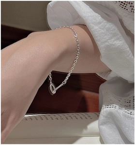 Close-up of minimalist S925 silver chain bracelet with T-bar toggle clasp on wrist