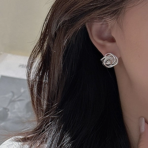 Elegant S925 sterling silver twisted rose stud earring shown on a model for daily wear