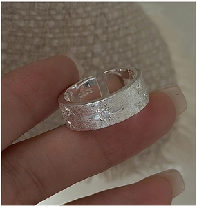 Macro detail of S925 sterling silver ring with frosted texture and star zircon inlay