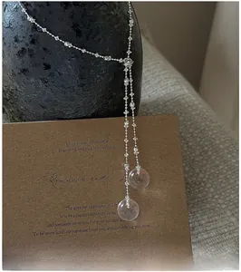 Detail of S925 silver Y-shaped necklace with pink crystal pendants on vintage card
