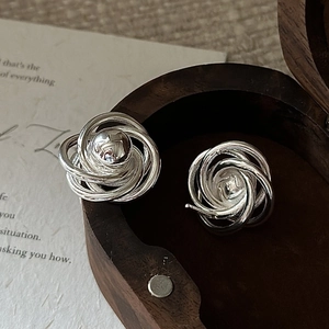 S925 sterling silver twist earrings with a bead center in a wooden jewelry box