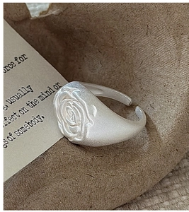Detailed macro shot of vintage matte silver rose ring with adjustable open band design