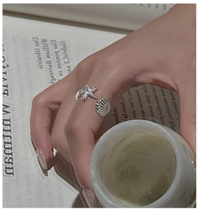 Detailed view of S925 sterling silver starfish and seashell open ring on hand