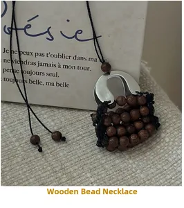Detail of a handmade wooden bead bag pendant necklace with a vintage woven aesthetic