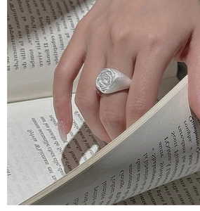Detailed view of an S925 sterling silver vintage rose ring worn during reading