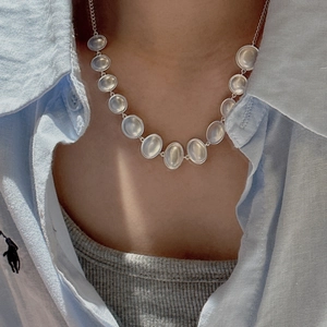 Minimalist S925 sterling silver necklace featuring oval links with milky white gemstones