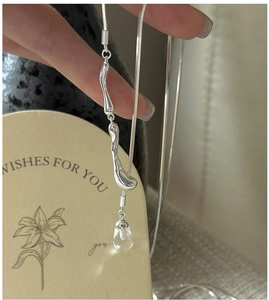 Close-up of S925 silver snake chain with teardrop crystal pendant and wavy metal links