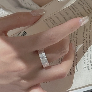 S925 sterling silver brushed star ring with vintage matte finish on hand with book