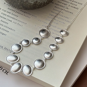 Minimalist S925 sterling silver necklace with matte oval pendants and brushed metal finish