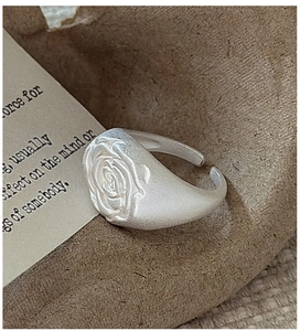 Macro shot of matte S925 sterling silver rose relief ring with fine frosted texture