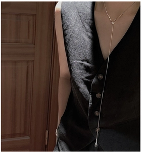 Close-up of a minimalist gold lariat necklace featuring a sleek Y-shaped drop design