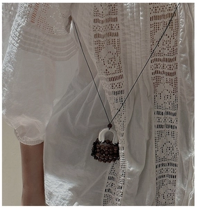 Detail of S925 silver handbag pendant with vintage woven dark wood beads on long black cord