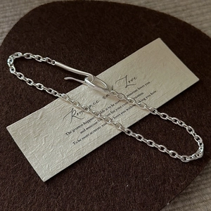 Minimalist S925 sterling silver chain bracelet with unique T-bar toggle clasp on paper