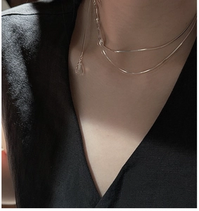 Detail of S925 sterling silver layered necklace with clear crystal teardrop pendant