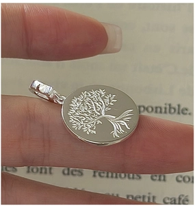 Macro shot of S925 sterling silver Tree of Life round pendant with intricate details