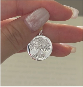 Detailed macro view of S925 sterling silver Tree of Life pendant with fine relief