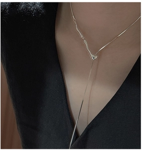 Macro detail of S925 sterling silver liquid metal style long necklace on a black outfit