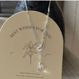 Detail of S925 sterling silver snake chain with lava texture and water drop crystal pendant