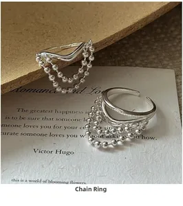 Macro shot of S925 sterling silver chain tassel ring with polished metallic texture