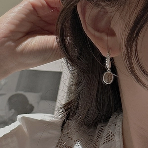 Retro S925 silver earrings with braided texture and brown coin pendant on model