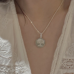 S925 sterling silver Tree of Life pendant necklace worn by a model on lace top
