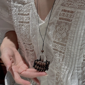 S925 silver necklace with a unique hand-woven bag pendant on a minimalist black cord