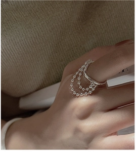 Detail view of multi-layer S925 sterling silver ring with elegant ball chain tassels