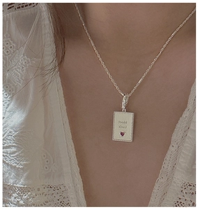 Detail of S925 silver necklace with Meet Luck pendant and pink heart gemstone