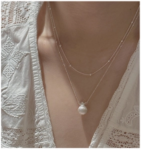 Close-up of S925 silver double-layered necklace featuring a matte ball pendant and bead chain