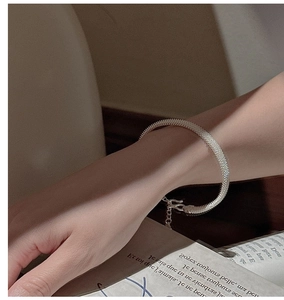 Close-up of S925 silver mesh bracelet with adjustable lobster clasp on a fashion magazine