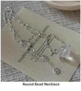 Detail of AG925 sterling silver beaded chain with a clear crystal sphere pendant