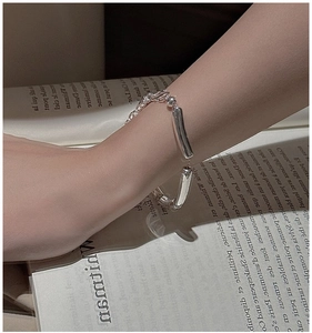 Detailed view of an S925 sterling silver hollow tube bracelet on a woman's wrist