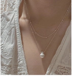 Close-up of S925 sterling silver layered necklace with frosted round crystal pendant